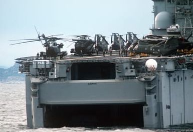 CH-46 Sea Knight and CH-53E Super Stallion helicopters are parked on the stern of the flight deck of the amphibious assault ship USS SAIPAN (LHA 2) participating in NATO Exercise NORTHERN WEDDING '86