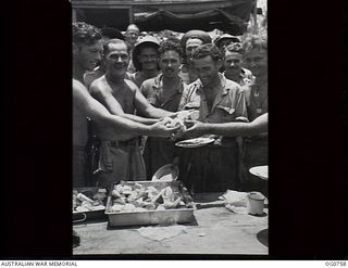 MOMOTE, LOS NEGROS ISLAND, ADMIRALTY ISLANDS. 1944-03-08. EVEN IN THE FRONT LINE, THE COOK CAN PRODUCE HOT SCONES. SHOWN: SERGEANT G. BUBB, PERTH, WA, HANDING OUT HOT SCONES FOR LUNCH. HOLDING A ..