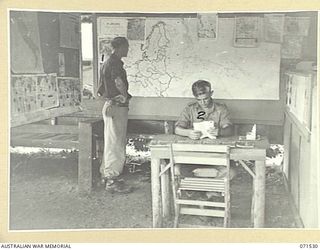 KOITAKI, PORT MORESBY AREA, NEW GUINEA, 1944-03-27. MEMBERS OF THE AUSTRALIAN ARMY EDUCATION SERVICE ATTACHED TO THE 113TH CONVALESCENT DEPOT AT THE NEWS BAY IN THE UNIT READING ROOM. IDENTIFIED ..
