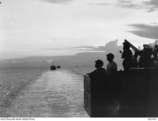 FINSCHHAFEN, NEW GUINEA, 1943-09-22. CONVOY OF LSTS (LANDING SHIPS, TANK), WITH THE FINSCHHAFEN FORCE ABOARD, APPROACHING THE ASSAULT BEACH. NOTE, ANTI-AIRCRAFT SHELLS BURSTING IN THE SKY