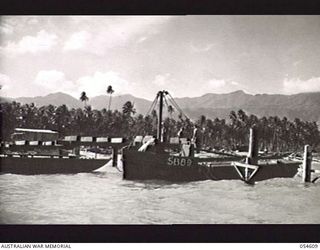 MILNE BAY, NEW GUINEA, 1943-07-11. THE NEW 960 FEET "T" JETTY BEING BUILT BY THE 4TH AUSTRALIAN FIELD COMPANY, ROYAL AUSTRALIAN ENGINEERS, TO ALLOW DISCHARGE OF PETROLEUM PRODUCTS IN BULK FROM ..