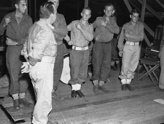 LAE, NEW GUINEA. 1944-06-08. MANY A LAUGH WAS PROVIDED AT THE 2/7TH ADVANCED WORKSHOP CONCERT WHEN PERSONNEL ATTEMPTED DRILL MOVEMENTS WITHOUT USING WEAPONS. THE CONCERT WAS HELD ON THE DAY MARKING ..