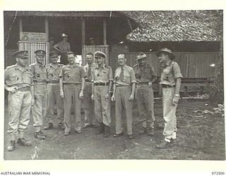 MILNE BAY, NEW GUINEA. 1944-04-21. THE HONOURABLE E.J. WARD, MINISTER FOR EXTERNAL TERRITORIES IN THE AUSTRALIAN GOVERNMENT (4), OUTSIDE HEADQUARTERS NAVAL OFFICER- IN- CHARGE, MILNE BAY BASE ..