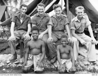 Native Privates Simet (5) and Marcus (6), among Royal Australian Naval Volunteer Reserve wireless personnel at the Allied Intelligence Bureau, Wunung Plantation. Identified personnel are: Able ..
