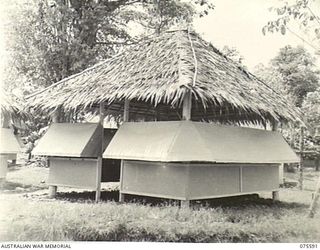 LAE, NEW GUINEA. 1944-08-28. A TYPICAL EXAMPLE OF AN OFFICE BUILT MAINLY OF NATIVE MATERIALS AT HEADQUARTERS, NEW GUINEA FORCE
