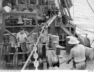 BOERA POINT, NEW GUINEA. 1943-10-01. ON BOARD THE SS MERNOO MARINE CABLE LAYING SHIP, SHOWING THE CABLE COMING THROUGH THE LEADS, DYNAMOMETER AND WINCH. THIS CABLE IS BEING LAID BETWEEN PORT ..