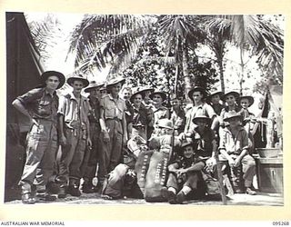 PALMALMAL, JACQUINOT BAY, NEW BRITAIN, 1945-08-13. MEMBERS OF HEADQUARTERS 5 DIVISION AWAITING TRANSPORT TO THE WHARF TO EMBARK ON THE TROOPSHIP VAN OUTHOORN FOR RETURN TO AUSTRALIA