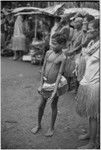 Mortuary ceremony, Omarakana: girl wearing short fiber skirt and mourning necklace (may hold fingernails or other relics of the deceased)