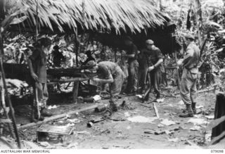 WARAPA AREA, BOUGAINVILLE ISLAND. 1945-02-13. TROOPS OF NO.8 PLATOON, 61ST INFANTRY BATTALION SEARCHING THE HEADQUARTERS, OF THE 2ND BN 13TH JAPANESE INFANTRY REGIMENT WHICH THEY CAPTURED DURING A ..