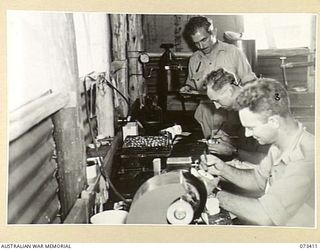 LAE, NEW GUINEA. 1944-05-24. DENTAL MECHANICS WORKING ON DENTURES IN THE DENTAL CLINIC AT THE 2/7TH GENERAL HOSPITAL. IDENTIFIED PERSONNEL ARE:- SX1693 STAFF-SERGEANT G.L. TRUSCOTT (1); SX30329 ..