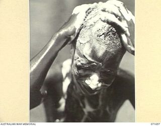 LAE, NEW GUINEA. 1944-03-25. A TUMARA NATIVE CLEANER WITH A LATHER OF SOAP AFTER WORK AT THE NATIVE LABOUR CORPS