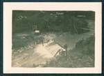 View of river, showing camp with buildings in background, [Bulolo?], New Guinea, c1932 to 1933