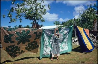 Mama Marenga Tarepo hanging tivaevae on a line