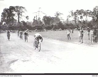 TOROKINA, BOUGAINVILLE, 1945-12-05. PRIVATE J. WALSH (1) WINNING THE A GRADE CYCLING EVENT AT THE 3 DIVISION AMENITIES ATHLETIC CARNIVAL HELD AT GLOUCESTER OVAL. PRIVATE F. GARNER (2) CAME SECOND, ..