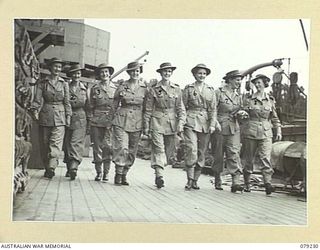 JACQUINOT BAY, NEW BRITAIN. 1945-02-24. SISTERS OF THE ARMY NURSING SERVICE ON THE STAFF OF THE 105TH CASUALTY CLEARING STATION WALKING ALONG THE DECK OF THE TROOPSHIP, THE SS "KATOOMBA". ..