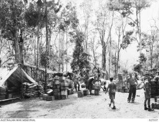 PAPUA, NEW GUINEA. 1942-10. SUPPLIES STACKED AT THE FOOT OF THE RAMP OF THE "FLYING FOX" CONSTRUCTED BY 2/6TH FIELD COMPANY, ROYAL AUSTRALIAN ENGINEERS. THE SUPPLIES ARE WAITING TO BE CONVEYED BY ..