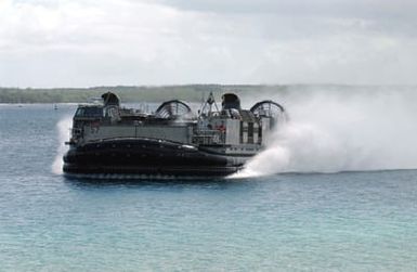 A US Navy (USN) Landing Craft, Air Cushioned (LCAC) speeds towards its landing point at Inner Apra Harbor, Guam. The LCAC along with its support ship is here to participate in Exercise TANDEM THRUST 2003