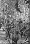 Pig festival, pig sacrifice, Kompiai: inside ritual fence, men wait to feed salted pork to allies