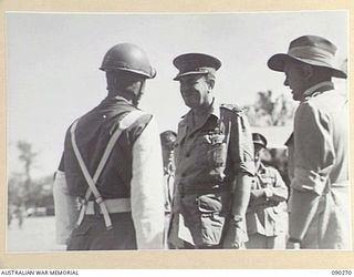 TOROKINA, BOUGAINVILLE. 1945-04-01. LORD WAKEHURST, GOVERNOR OF NEW SOUTH WALES (2), AT PIVA AIRSTRIP SAYING GOODBYE TO THE SERGEANT OF THE GUARD WHO PROVIDED HIS ESCORT THROUGHOUT HIS OFFICIAL ..