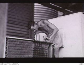 17 MILE, LALOKI RIVER, NEW GUINEA. 1943-11-22. NX24379 STAFF SERGEANT L. H. TICKERING, NON-COMMISSIONED OFFICER IN CHARGE OF THE CORDIAL FACTORY, ESTABLISHED AND RUN BY THE AUSTRALIAN DEFENCE ..