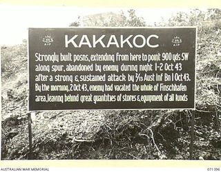 KAKAKOG, FINSCHHAFEN AREA, NEW GUINEA. 1944-03-20. ONE OF MANY BATTLE SIGNS IN THE FINSCHHAFEN AREA, THIS SIGN RECORDS THE ACTIVITIES OF THE 2/13TH INFANTRY BATTALION