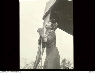 TADJI NEAR AITAPE, NORTH EAST NEW GUINEA. C. 1944-10. ANNE TRIOLA, A MEMBER OF THE CONCERT PARTY, ENTERTAINING ON STAGE AT A SHOW FOR PERSONNEL OF NOS. 8 AND 100 (BEAUFORT) SQUADRONS RAAF