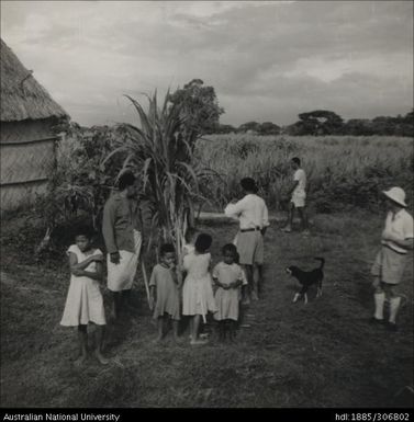 Field Officer with farmer and his family