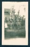 New Ireland sing sing, showing group of men, two dressed in traditional clothes, New Guiena, c1929 to 1932