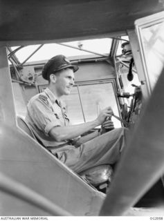 BOUGAINVILLE ISLAND, SOLOMON ISLANDS. 1945-01-12. 434270 FLYING OFFICER J. A. RUSSELL, MURWILLUMBAH, NSW, AT THE CONTROLS OF HIS TINY AUSTER AIRCRAFT OF NO. 17 AIR OBSERVATION PORT FLIGHT RAAF AT ..