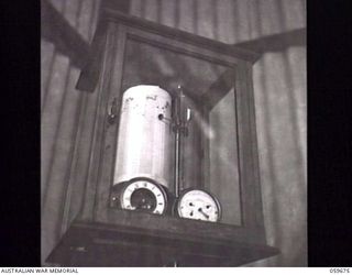 BOMANA, NEW GUINEA. 1943-11-08. INSTRUMENTS FOR MEASURING THE QUANTITY OF WATER PUMPED TO PORT MORESBY FROM THE BOMANA PUMPING STATION