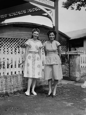 [Portrait of two women in front of house]