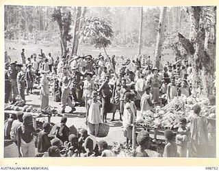 RABAUL, NEW BRITAIN. 1945-11-10. TRADING TAKING PLACE AT THE NATIVE MARKET AT TALILI BAY IN 4 INFANTRY BRIGADE AREA