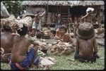 Mortuary ceremony: women participate in ritual exchange of banana leaf bundles and foods