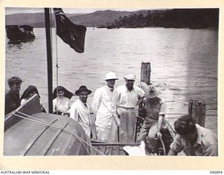 TOBOI WHARF, NEW BRITAIN. 1945-09-16. MISSIONARY SISTERS AND PRIESTS FROM THE RAMALE MISSION STANDING AT THE STERN OF THE MOTOR LAUNCH GLORIA, OPERATED BY 16 SMALL SHIPS COMPANY. THEY ARE BEING ..