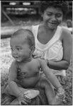 Smiling young woman and infant