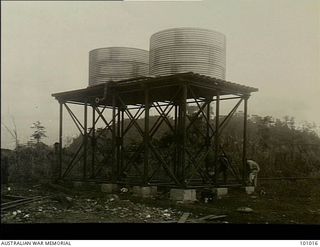 Lae, New Guinea. 1945-05-24. A prefabricated tubular steel tank stand holding two 3,000 gallon water tanks. Designed to withstand tropical conditions