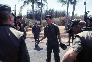 SSGT Richard Bishop, a Marine Corps instructor, critiques the performance of a group of Air Force security policemen who have just completed an anti-terrorist operation. The policemen are participating in an anti-terrorist exercise being conducted by the 1st Marine Brigade School