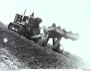 WARDS STRIP, PORT MORESBY, NEW GUINEA, 1943-03. A CRAWLER TRACTOR TOWING A RIPPER UPHILL. THE DRIVER IS A MEMBER OF NO. 2 OR NO. 5 MOBILE WORKS SQUADRON (LATER AIRFIELD CONSTRUCTION SQUADRON). ..