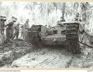 MADANG, NEW GUINEA. 1944-10-12. A CHURCHILL V TANK BOGGED DOWN FOR RECOVERY DURING TESTS CONDUCTED AT HQ 4 ARMOURED BRIGADE