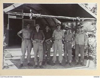 TOROKINA, BOUGAINVILLE. 1945-04-16. CAPTAIN F.R. BADGERY-PARKER, DEPUTY ASSISTANT DIRECTOR EDUCATION, AUSTRALIAN ARMY EDUCATION SERVICE, ATTACHED HEADQUARTERS 2 CORPS (1), WITH MEMBERS OF HIS STAFF ..