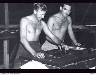 RABAUL, NEW BRITAIN, 1946-03-27. SERGEANT J. HENLEY (1) AND PRIVATE D. WALLACE (2), STAFF MEMBERS OF THE ARMY NEWSPAPER GUINEA GOLD, WORKING ON THE COMPOSING BLOCK. THE NEWSPAPER CHANGED ITS ..