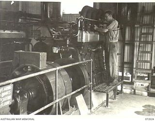 MILNE BAY, NEW GUINEA. 1944-04-04. QX55051 SAPPER P.A. PEAREN (1), A MEMBER OF THE 5TH ARMY TROOPS COMPANY, QUEENSLAND LINES OF COMMUNICATION AREA, ROYAL AUSTRALIAN ENGINEERS, ADJUSTS THE MOTOR ..