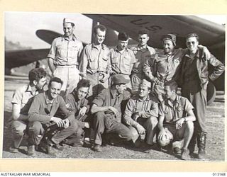 Port Moresby (?) New Guinea. 1942-09-02. A group of United States Army Air Force (USAAF) pilots and their RAAF co-pilots standing under the wing of a C-110 (DC-5) transport aircraft