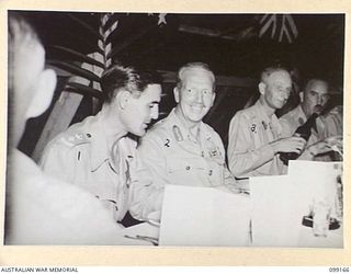 LAE, NEW GUINEA, 1945-12-01. MAJOR-GENERAL H.C.H. ROBERTSON, GENERAL OFFICER COMMANDING FIRST ARMY (2) AND COLONEL G.H.S. MORAN, DEPUTY DIRECTOR OF ELECTRICAL AND MECHANICAL ENGINEERING, FIRST ARMY ..