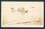 Two boats approaching shore, traditional outrigger canoe in front with three young girls and a man, behind four people stand on deck of boat, New Britain coast, approximately 30 miles north of Rabaul, New Guinea, c1929 to 1931