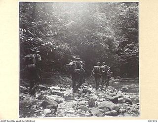 GAZELLE PENINSULA, NEW BRITAIN, 1945-05-14. TROOPS OF A COMPANY, 37/52 INFANTRY BATTALION, ON THE MARCH DURING THEIR TREK FROM RILE TO MAVELU, OPEN BAY