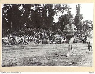 TOROKINA, BOUGAINVILLE, 1945-07-15. LEADING AIRCRAFTMAN T. ARGUE, ROYAL AUSTRALIAN AIR FORCE (1), AND CORPORAL J.A. BARTER, 12 ADVANCED WORKSHOP (2), TAKING PART IN THE COMBINED ALLIED SPORTS ..