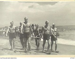 TOROKINA, BOUGAINVILLE, 1944-11-19. THE SURF LIFE SAVING TEAM OF THE 2/8TH CAVALRY COMMANDO SQUADRON MARCHING PAST THE CONTROL TOWER AT THE SURF CARNIVAL ORGANISED BY HEADQUARTERS 3RD DIVISION. ..