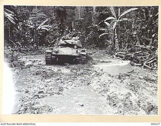 TOROKINA, BOUGAINVILLE, 1945-08-02. AN M24 GENERAL CHAFFEE LIGHT TANK SUCCESSFULLY NEGOTIATING A SWAMP WHICH HAD BOGGED A MATILDA TANK. THE M24 IS TAKING PART IN TRIALS CONDUCTED FOR THE WAR OFFICE