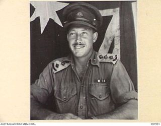CAPE WOM, WEWAK AREA, NEW GUINEA. 1945-10-17. CAPTAIN H.A. HERON, CAMP COMMANDANT, HEADQUARTERS 6 DIVISION